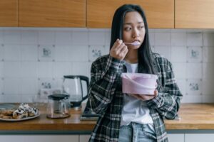 A picture of a sad woman eating ice cream